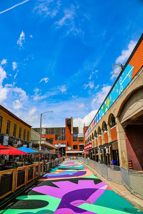 Colourful art covering road beside market patio