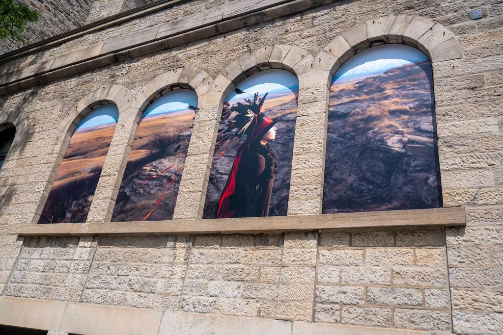 Meryl McMaster's artwork Edge of a Moment Variation I installed in the Dark Fork windows in downtown Ottawa.